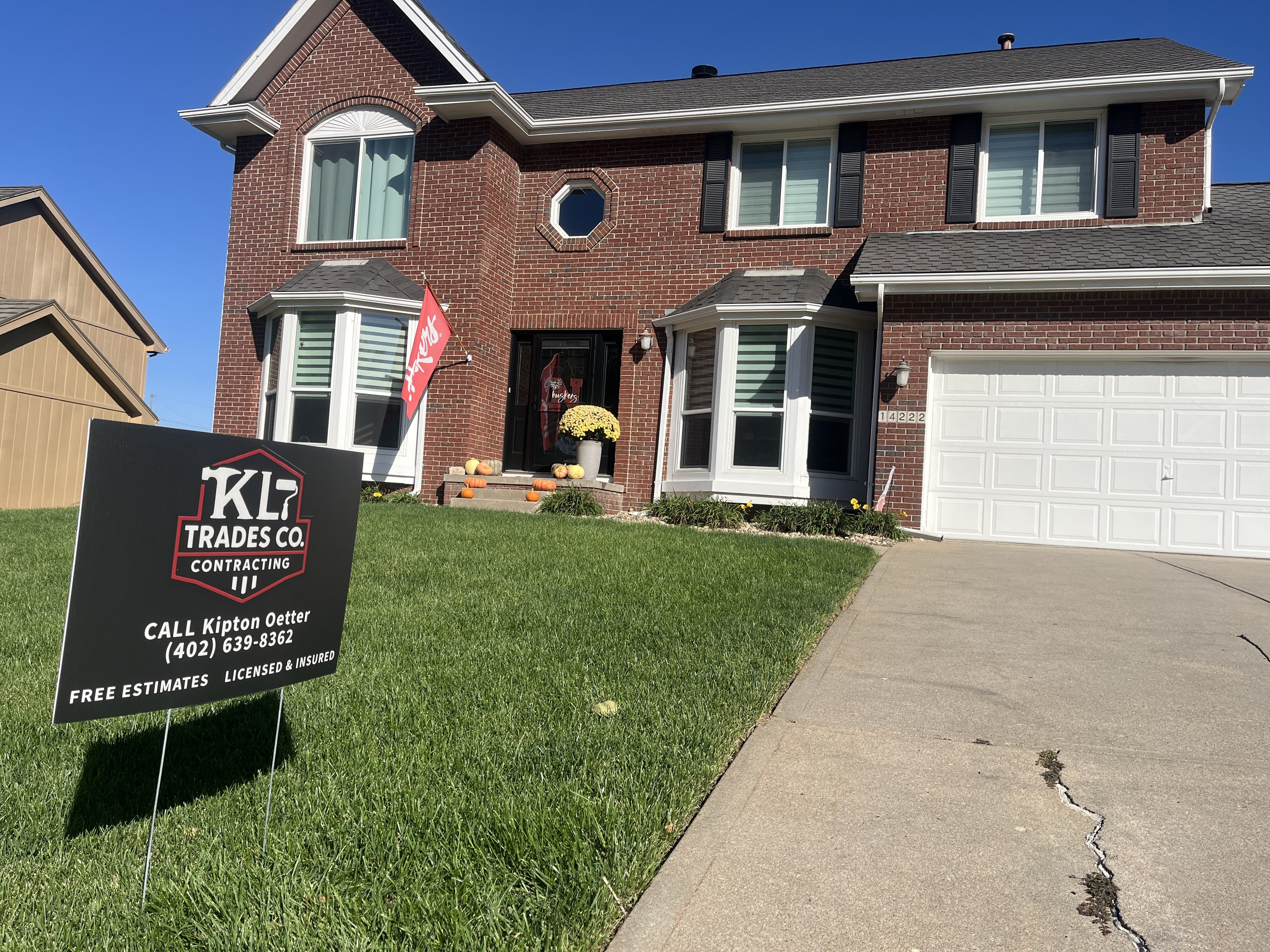 Full exterior repaint of a brick two-story home in the Omaha metro